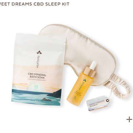 A bag of cbd mineral bath soak , a sleep mask , and a bottle of cbd oil.