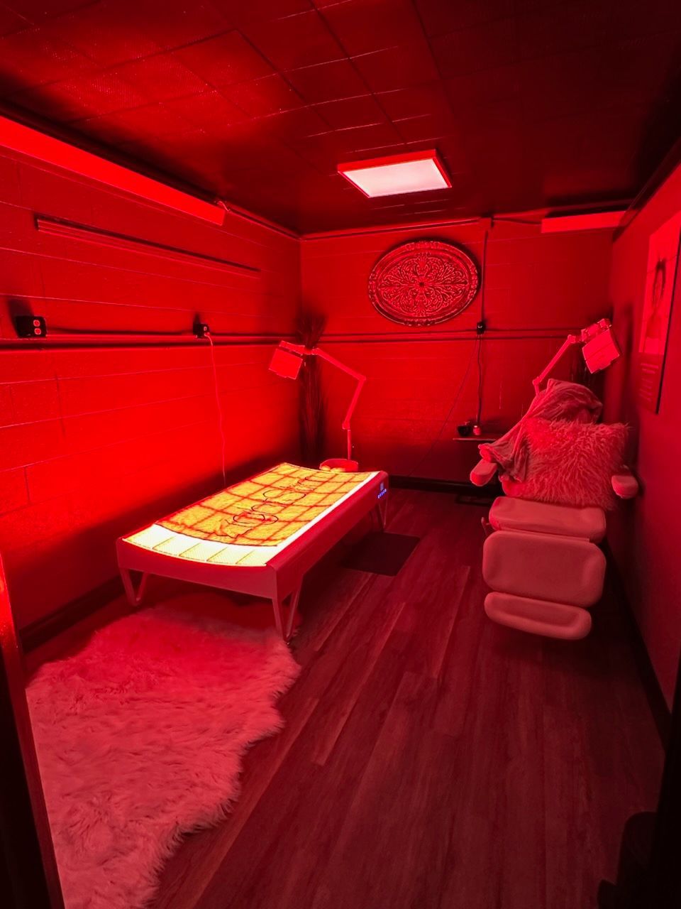 A person is getting a red light treatment on their hands