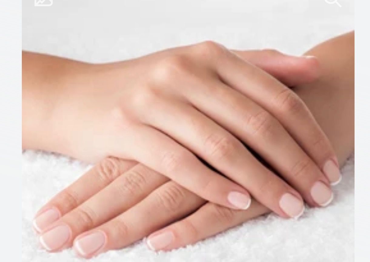 A close up of a woman 's hands on a white towel.