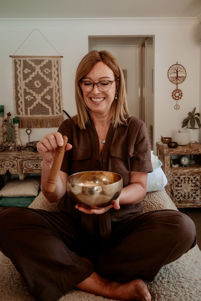Linda Allen in clinic with a singing bowl