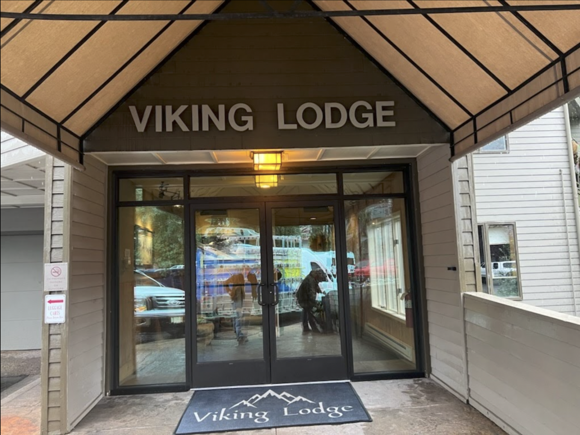 the entrance to the viking lodge is shown with windows and doors installed by Sun Glass