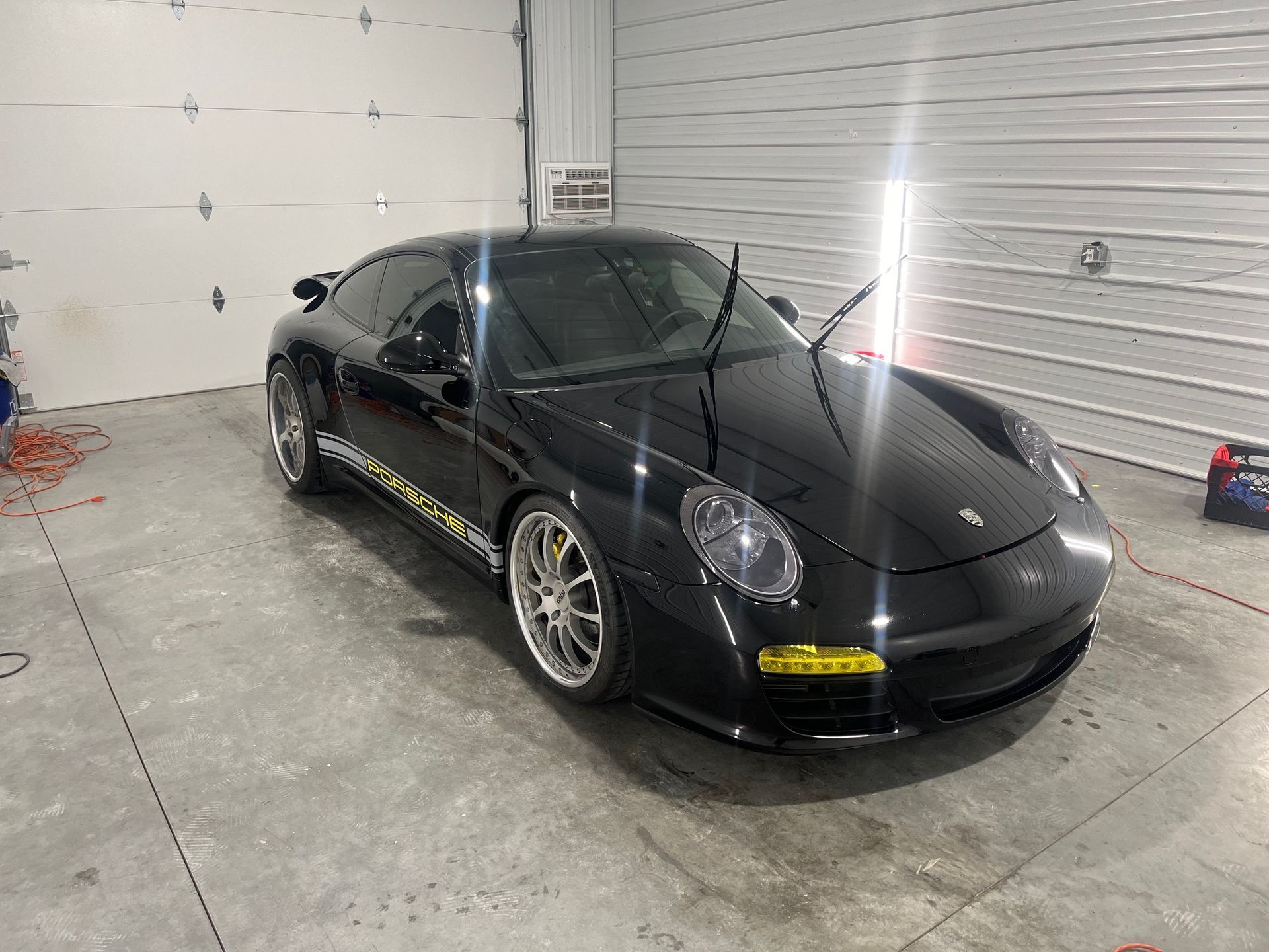 A blue car is shown before and after a one step paint correction