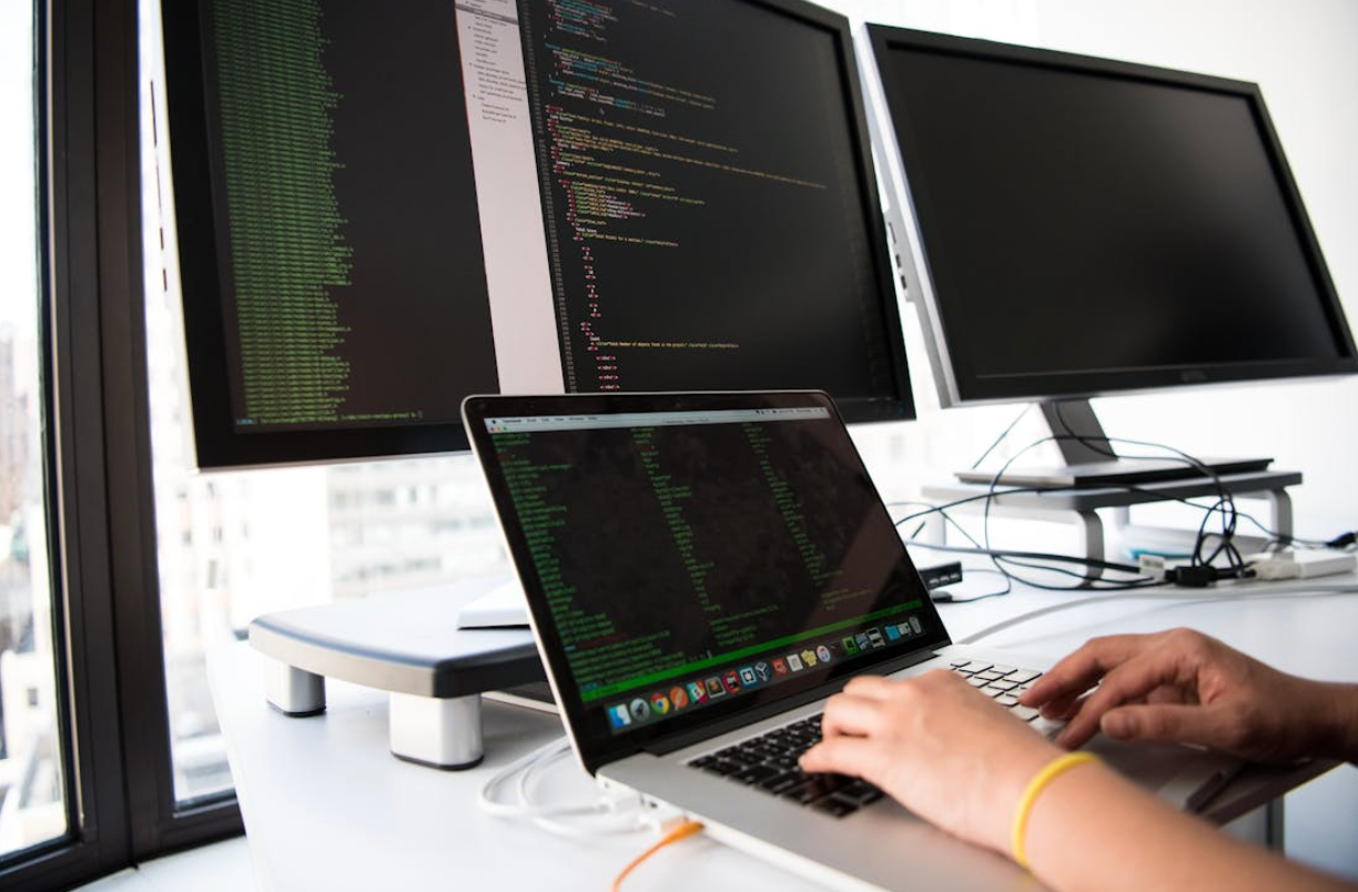 hands with computer screens inside the office