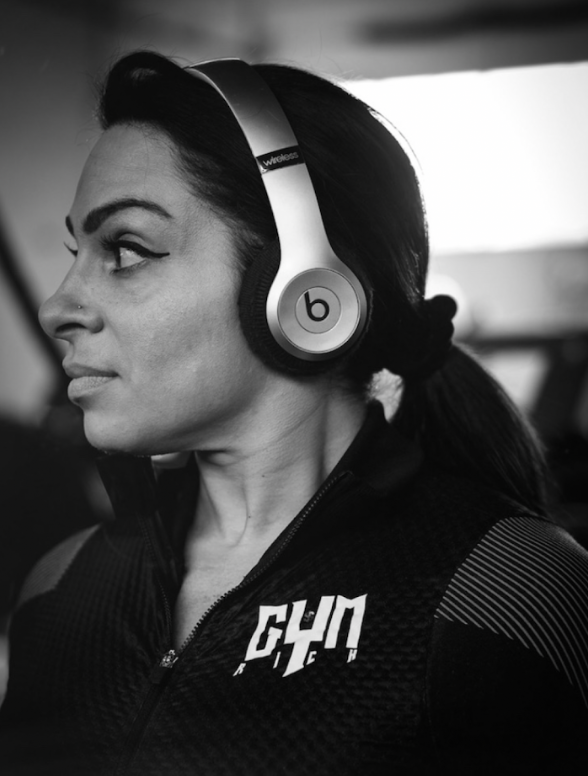 A black and white photo of a woman wearing beats headphones