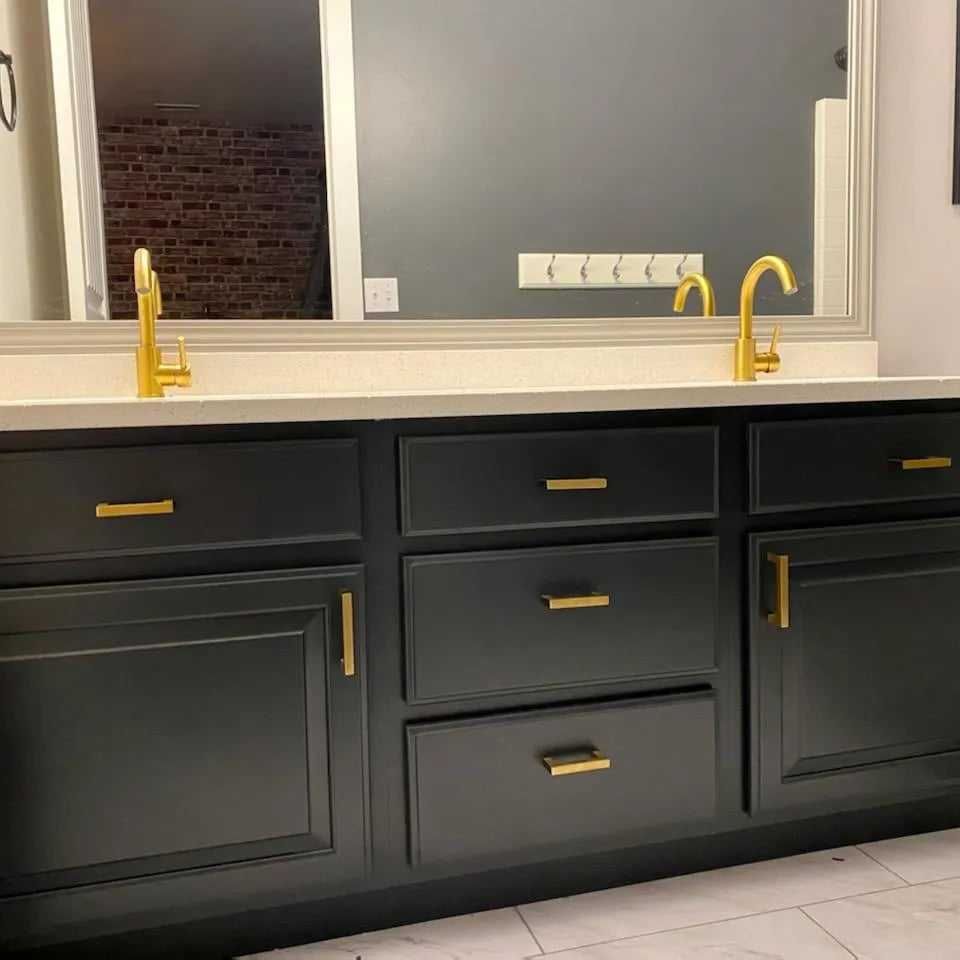 A bathroom vanity with two sinks and a mirror.