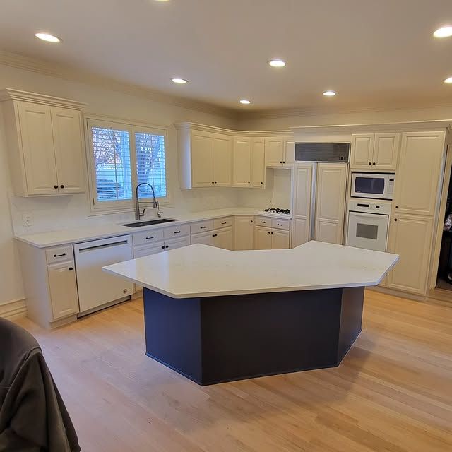There is a large island in the middle of the kitchen.