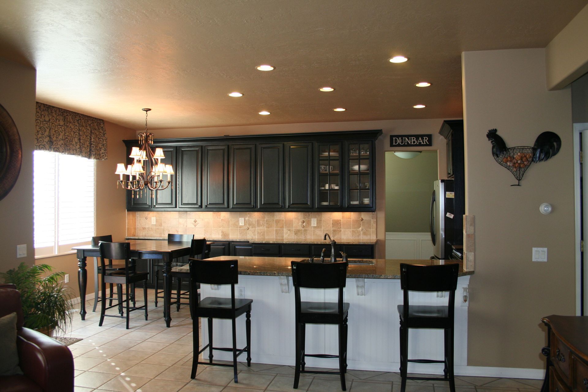 A kitchen with black cabinets and white counter tops