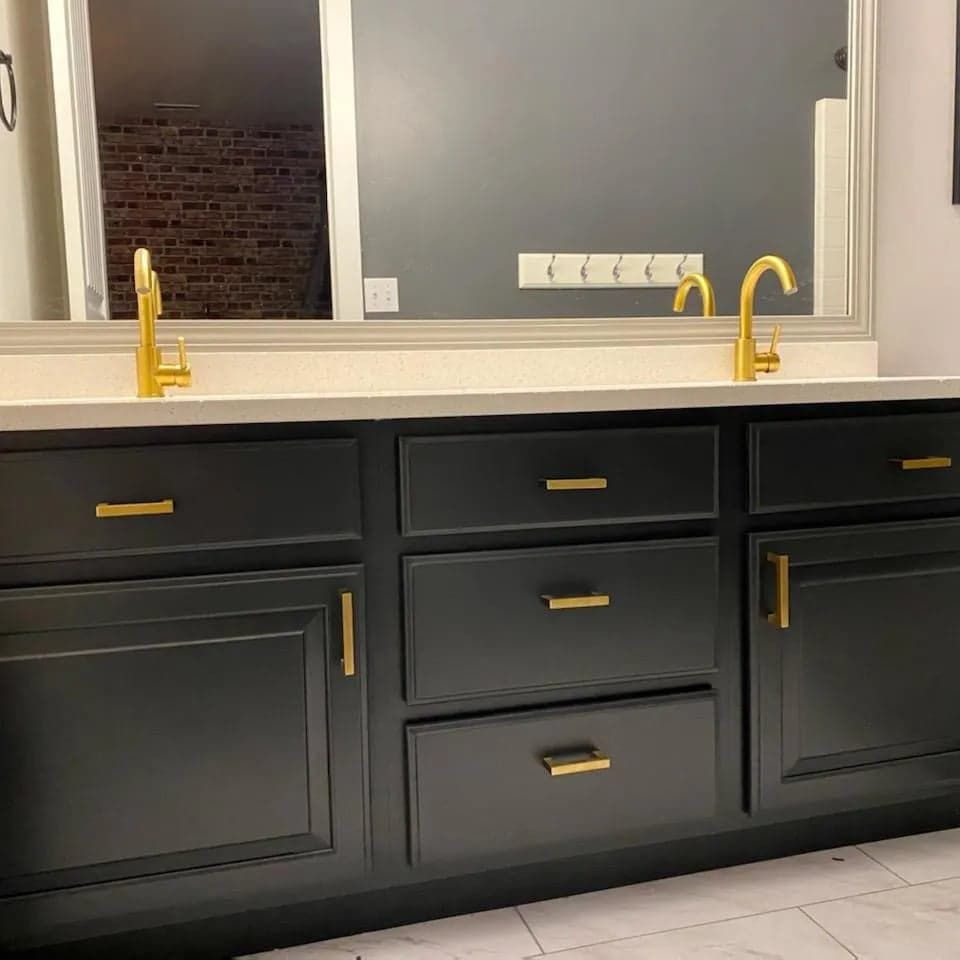 A bathroom vanity with two sinks and a mirror.