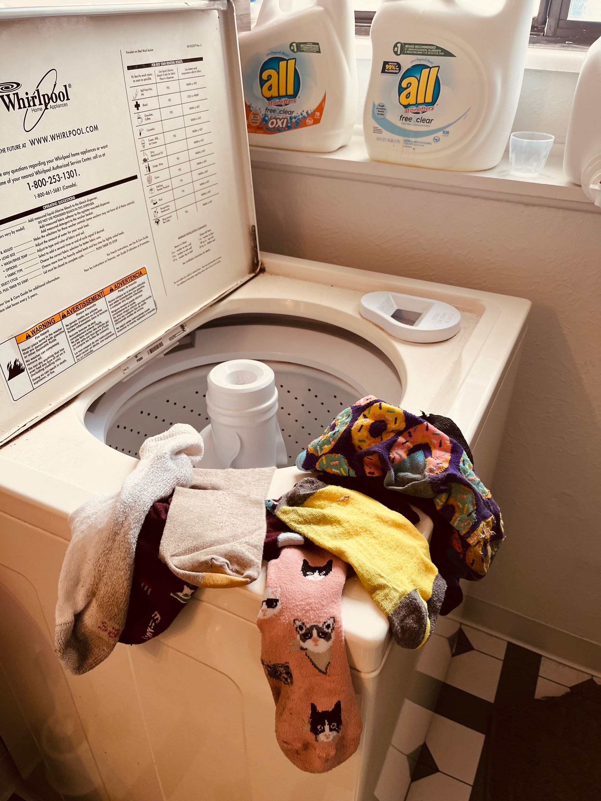 A washing machine with a lot of clothes in it
