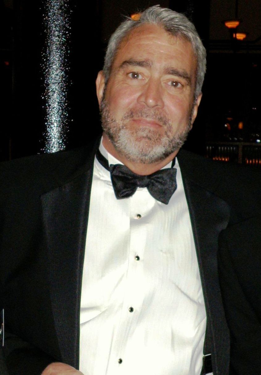 A man with a beard wearing a tuxedo and bow tie