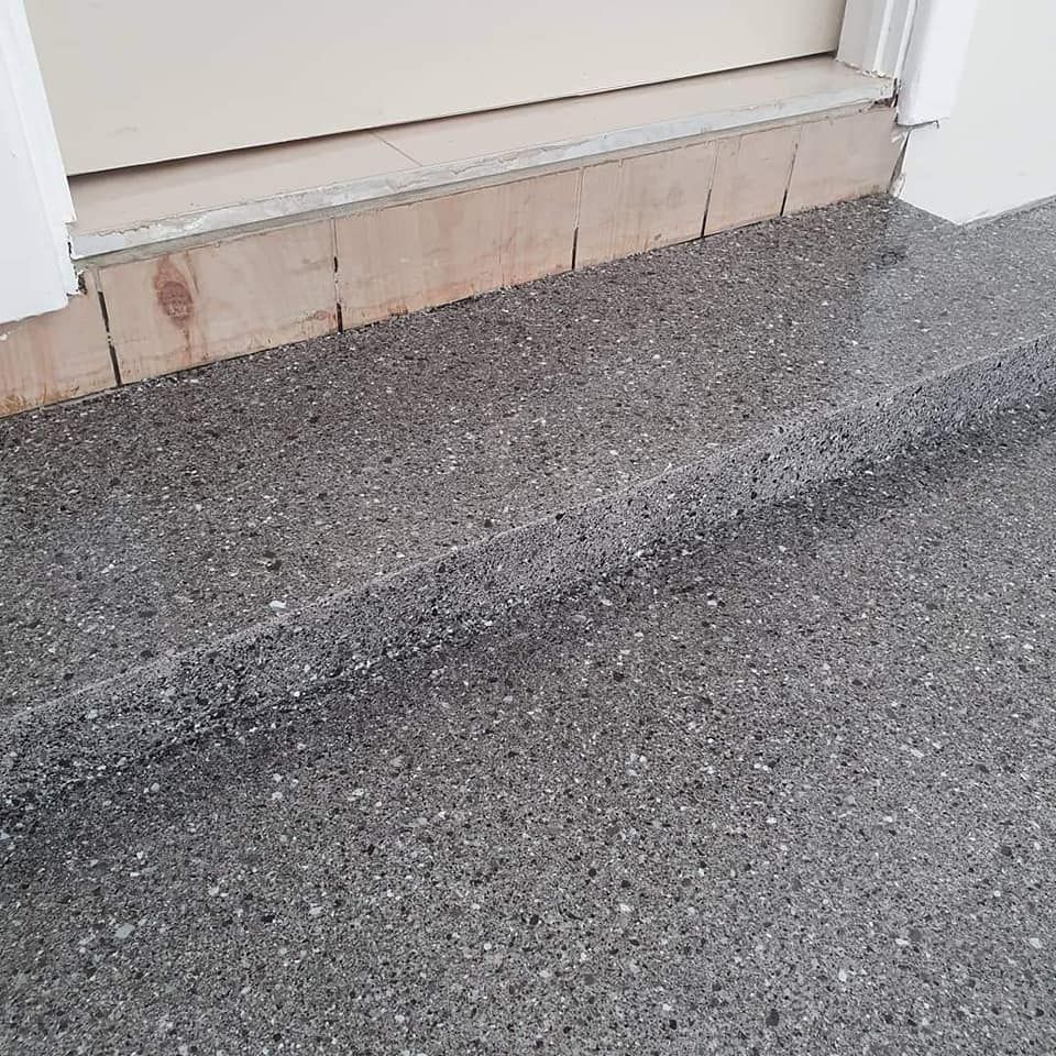 A close up of a concrete floor next to a door. — Partlic Painting & Epoxy Flooring In Wingham, NSW