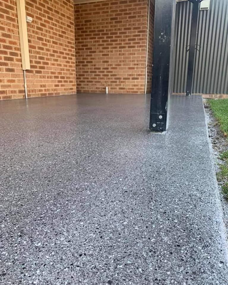 There is a brick wall in the background and a concrete floor in the foreground. — Partlic Painting & Epoxy Flooring In Wingham, NSW