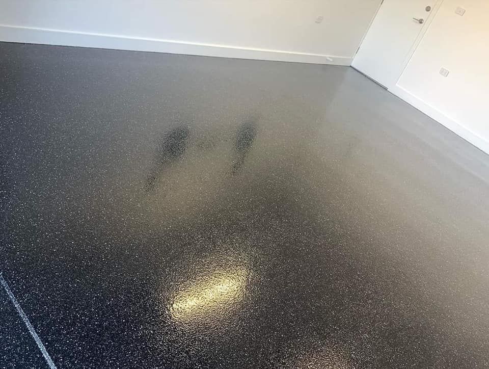 A Black Floor In A Room With A White Wall — Partlic Painting & Epoxy Flooring In Taree, NSW
