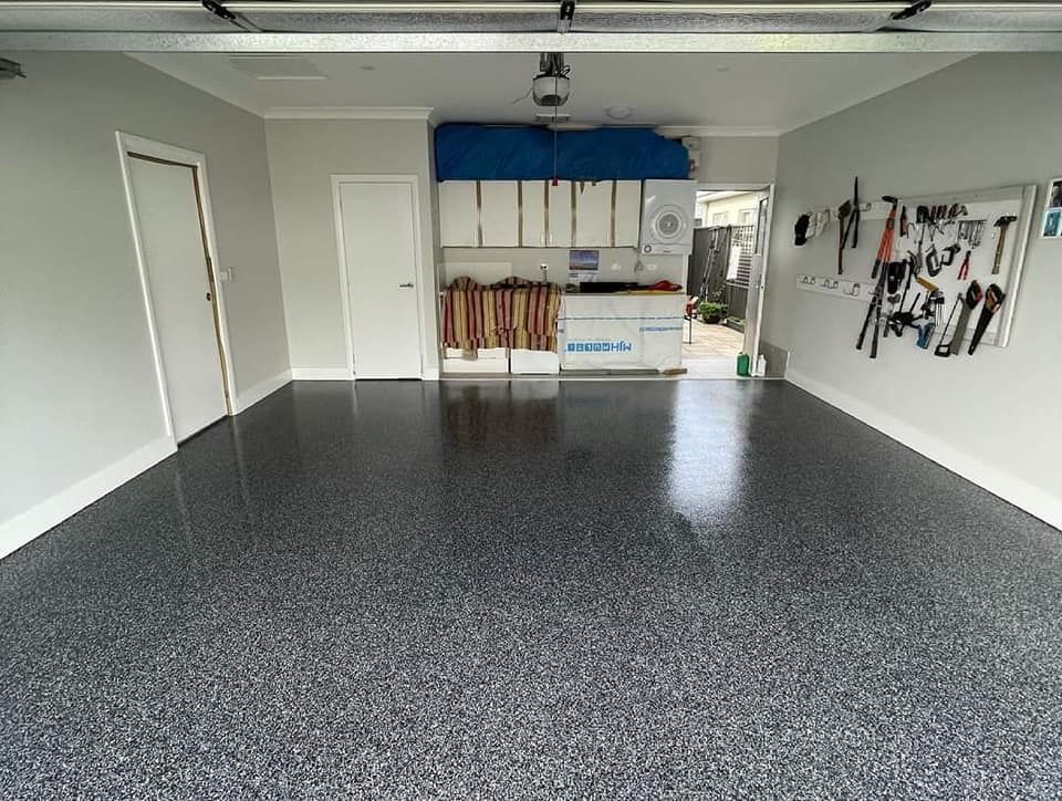 A Garage With A Gray Floor And White Cabinets — Partlic Painting & Epoxy Flooring In Taree, NSW