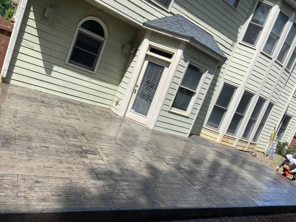 A swimming pool is being built in the backyard of a house.