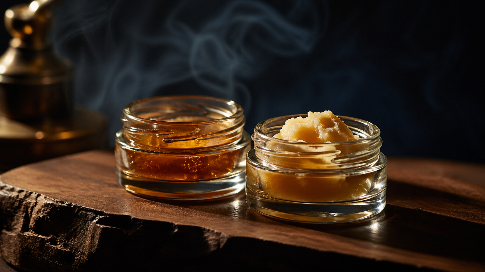 Two craft cannabis concentrate jars side by side on walnut, amber live resin and pale live rosin.