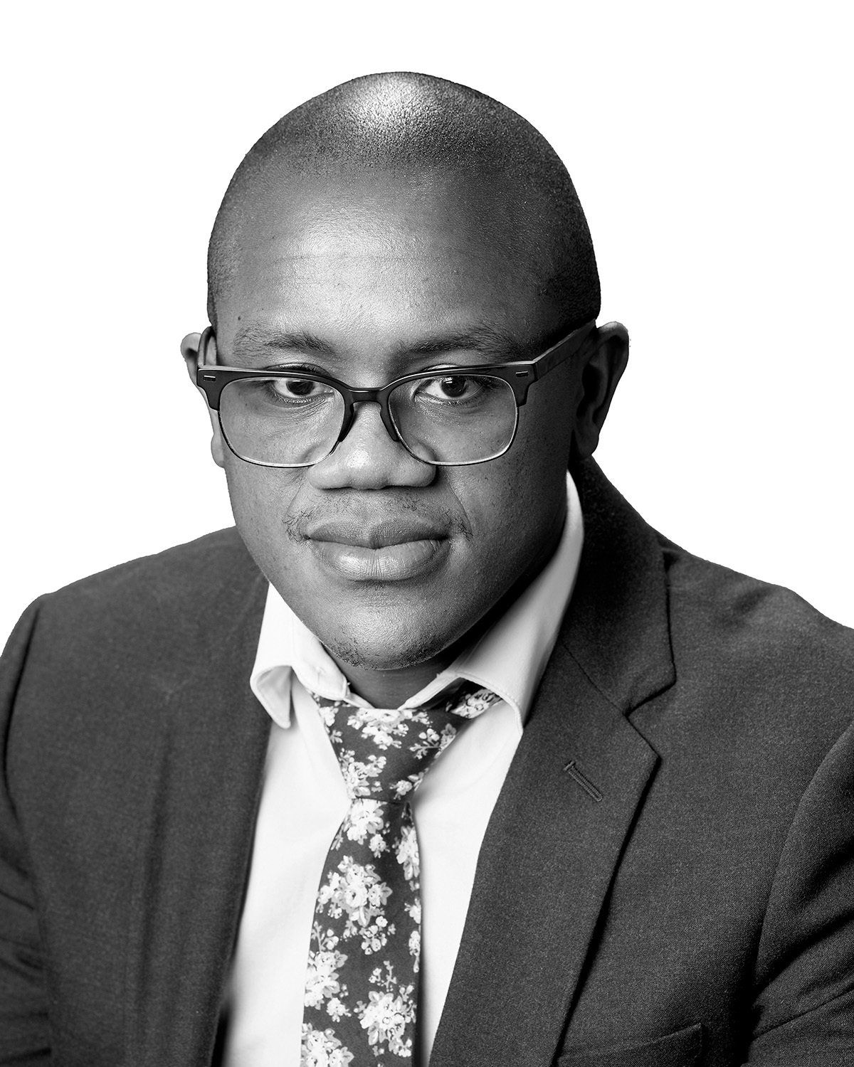 A man in a suit and tie is wearing glasses.