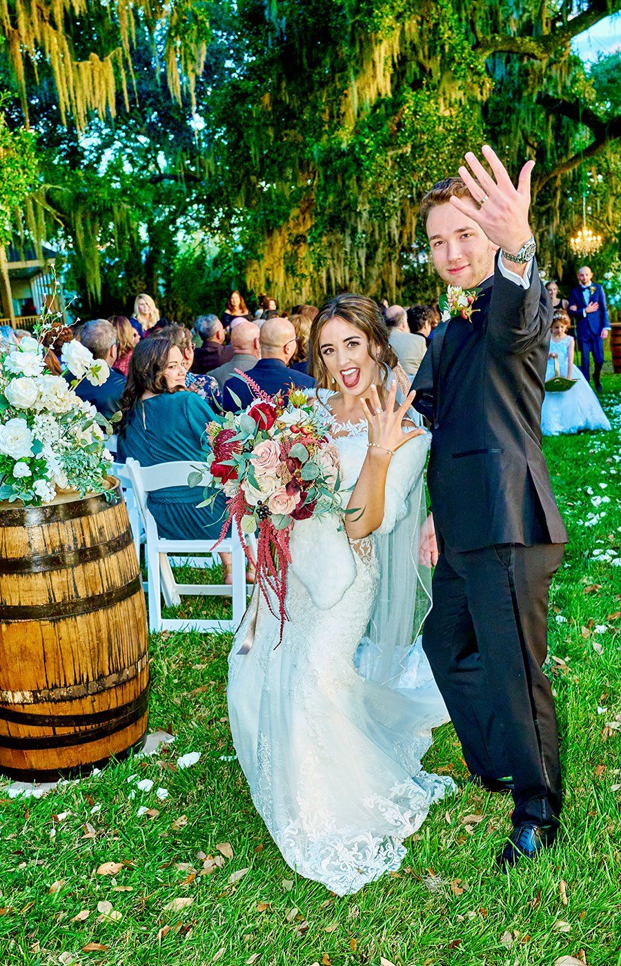 A bride and groom are posing for a picture at their wedding.