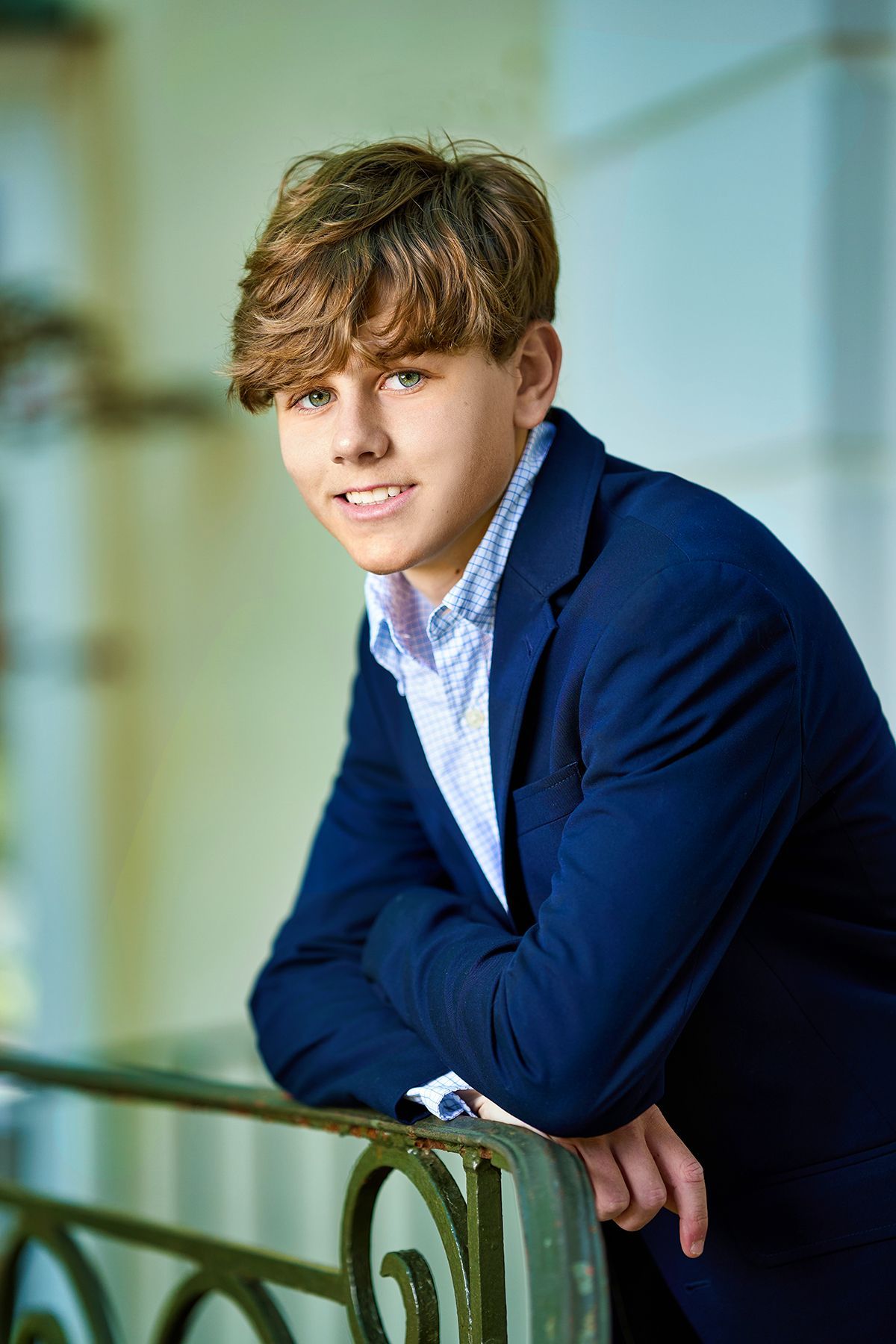 A black and white photo of a young man wearing a letterman jacket.