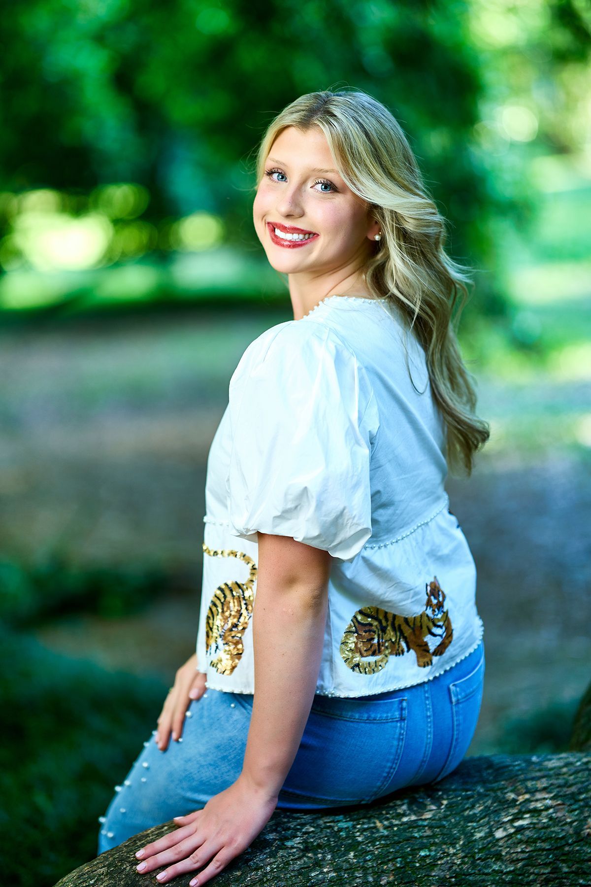 A woman in a sweater and short skirt is standing next to a set of stairs.