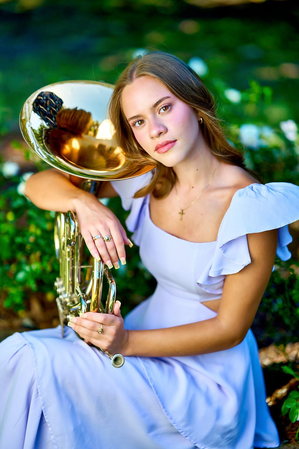 A ballerina is sitting on a chair with her legs crossed.