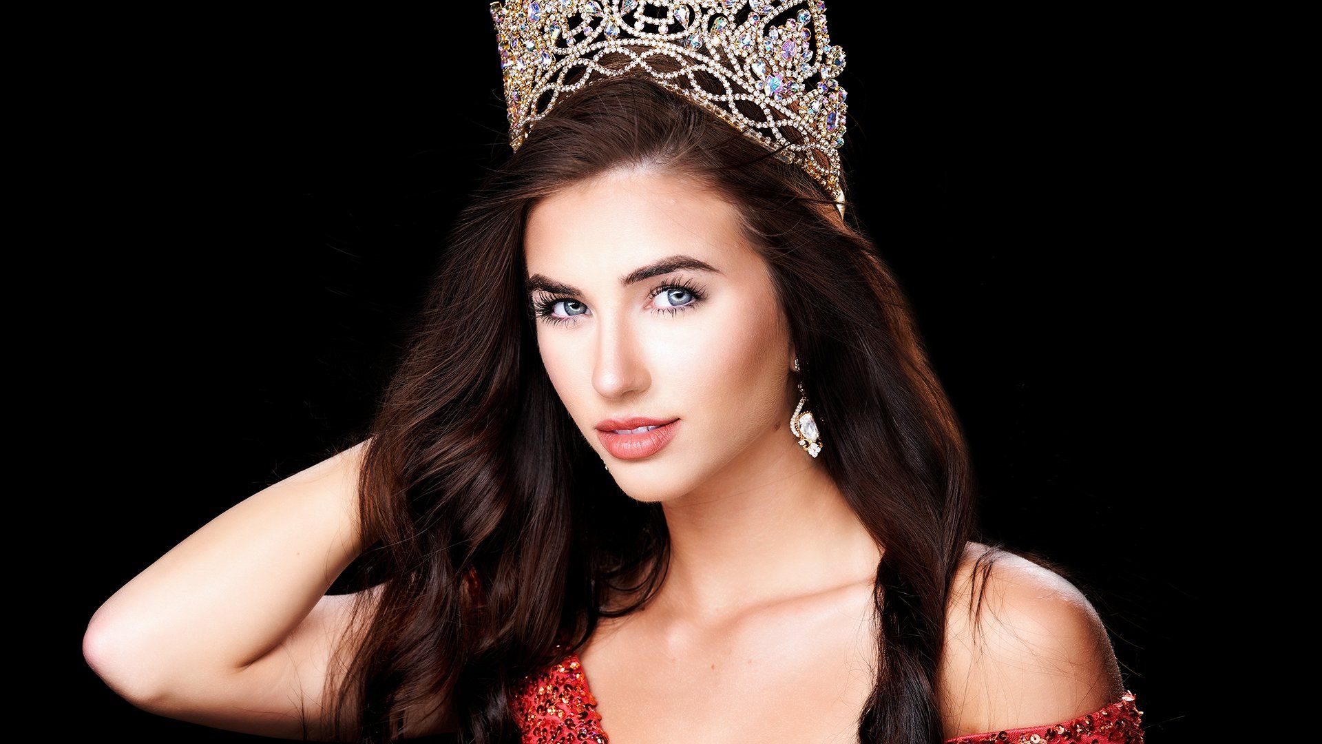 A woman is wearing a crown on her head.