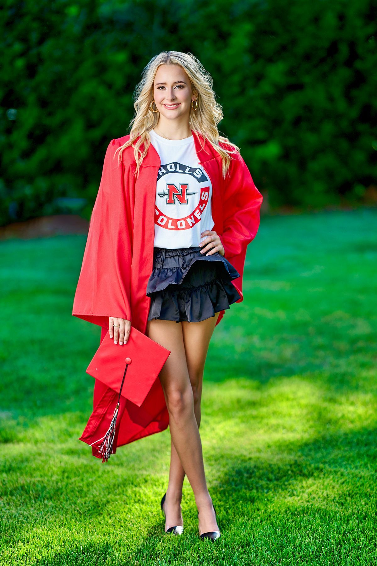A woman in a blue shirt and jeans is sitting on the floor.