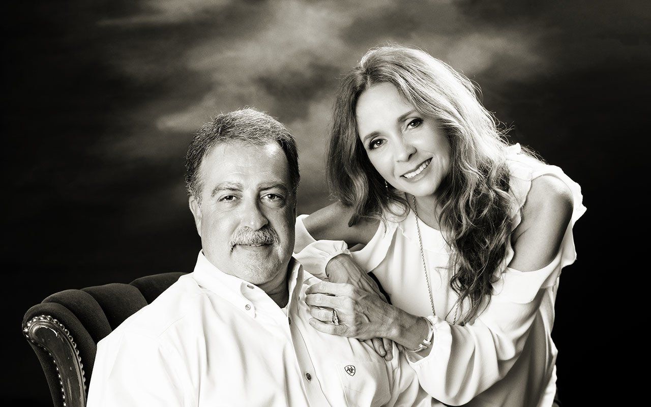 A man and a woman are posing for a black and white photo.