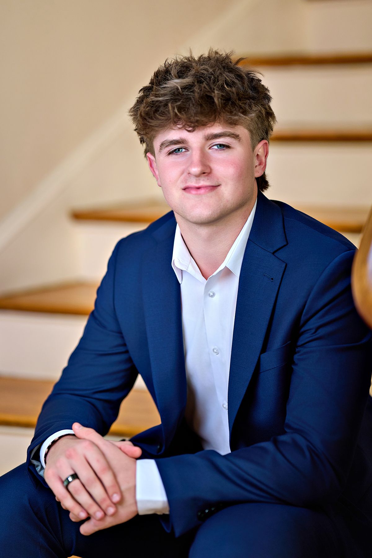 A black and white photo of a young man holding a baseball glove.