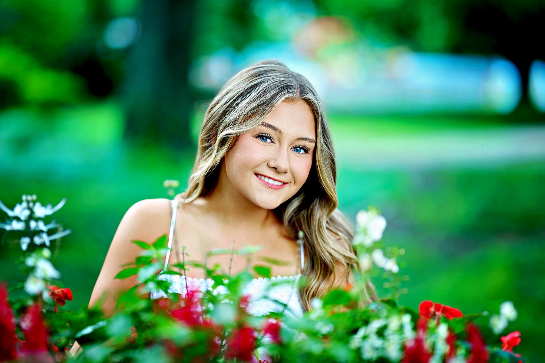 The girl is wearing a pink shirt and smiling for the camera.