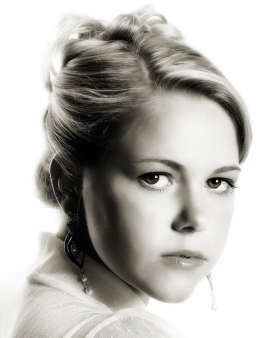 A black and white photo of a woman 's face