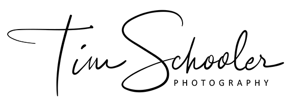 A black and white logo for tim schooler photography.