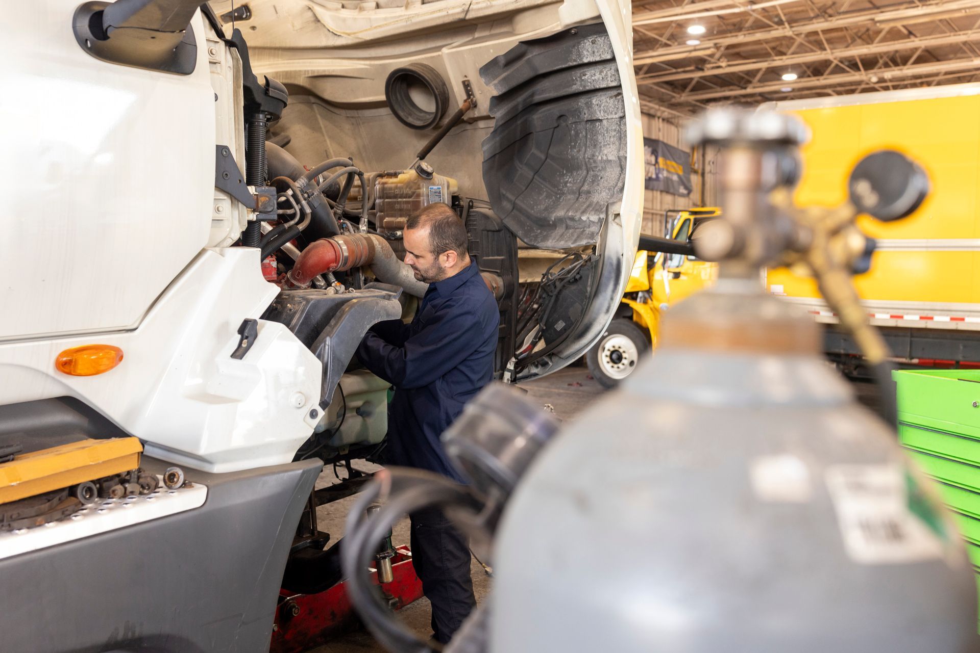 Mechanic working on truck engine. Mechanic working on truck engine.