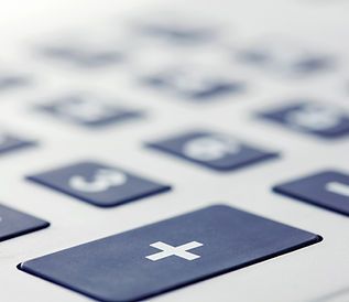 A close up of a calculator with a plus button