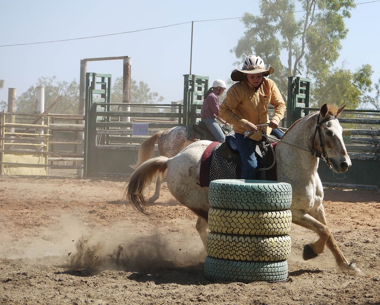 Cowboy competing in barrel racing at a local equestrian event, showcasing agility and speed around a barrel.