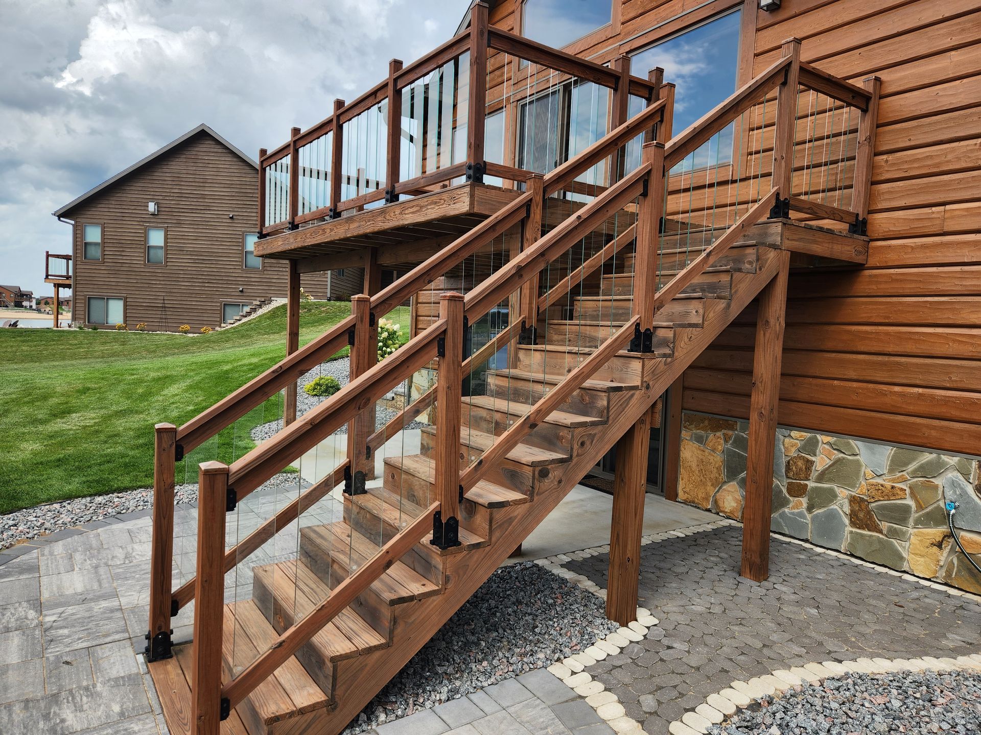 A person is painting a wooden railing with a brush.
