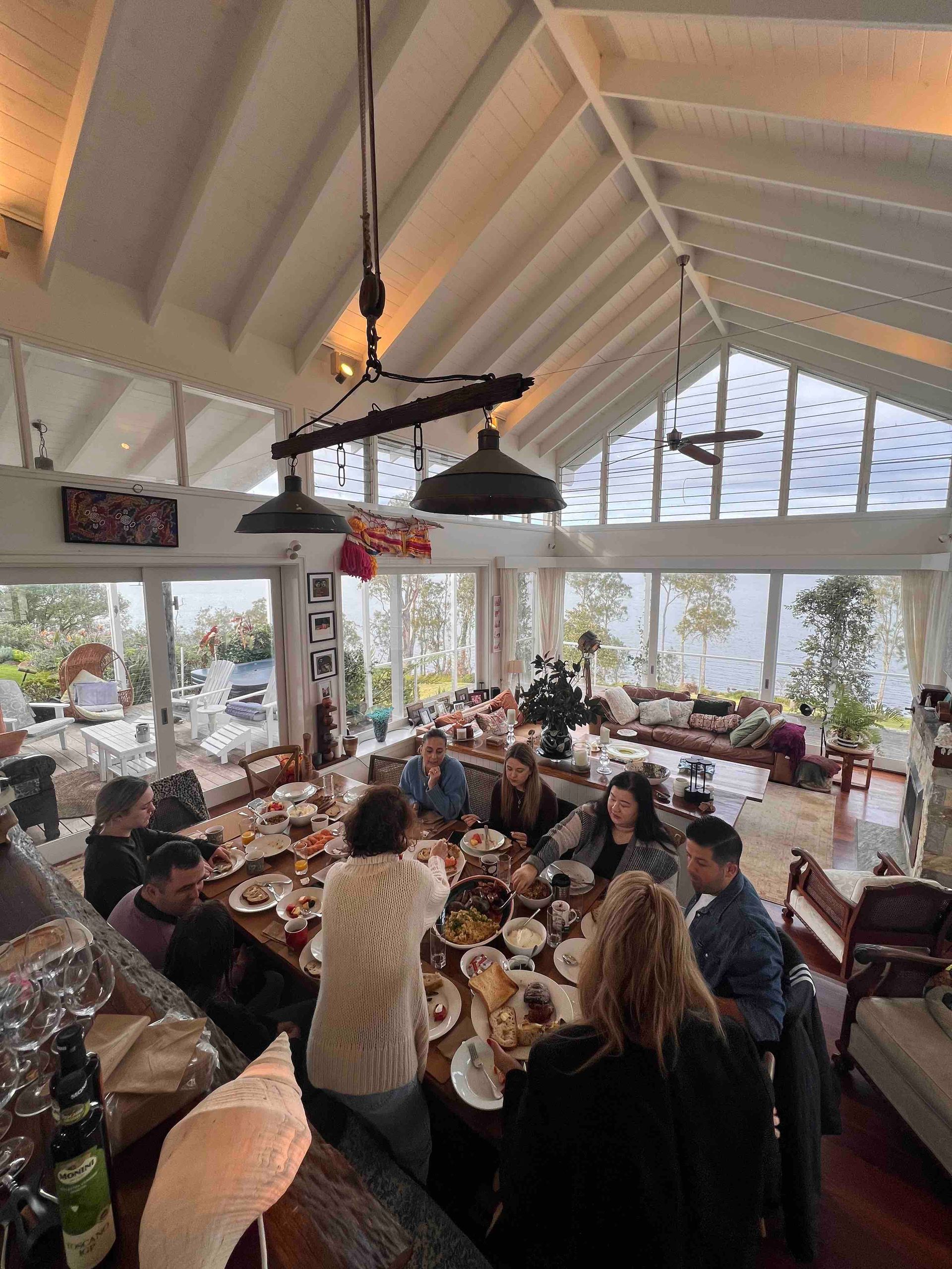A group of people are sitting at tables in a large room eating food.