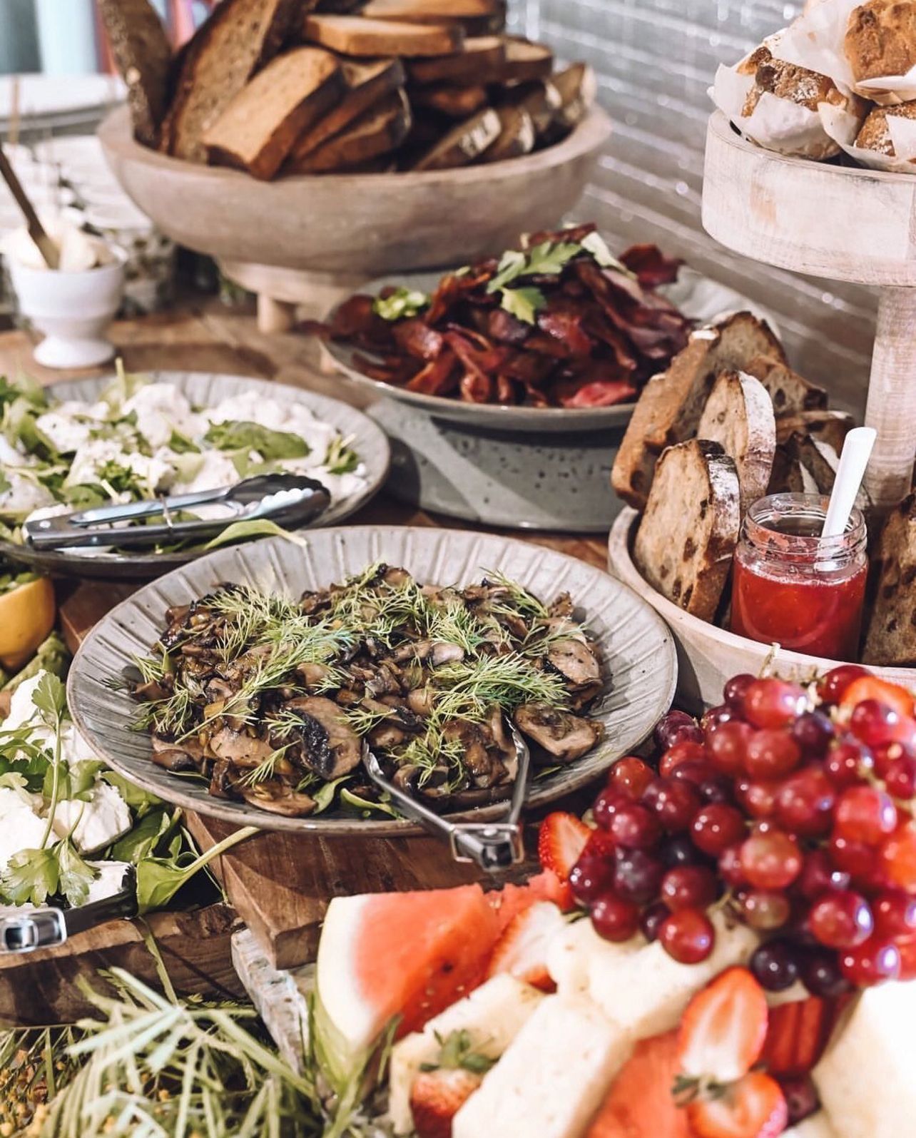A table topped with plates of food and fruit.