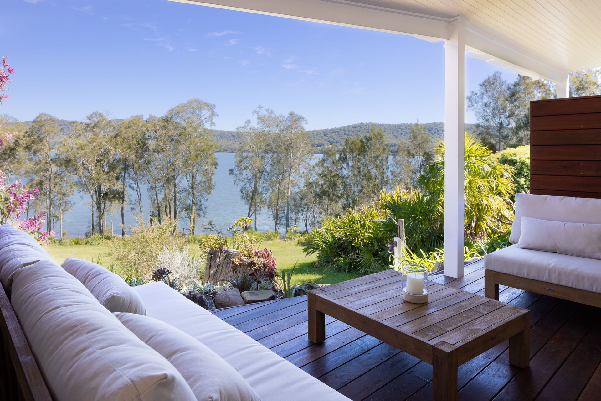 A patio with a view of a lake and trees