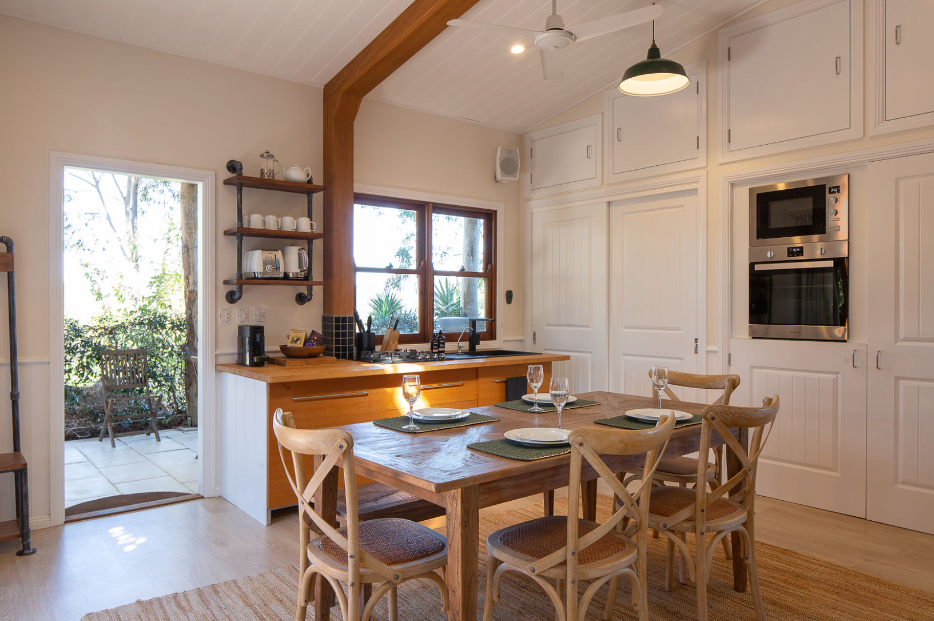 A kitchen with a table and chairs in it
