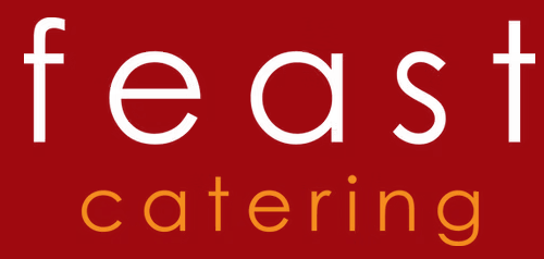 A red and white logo for feast catering