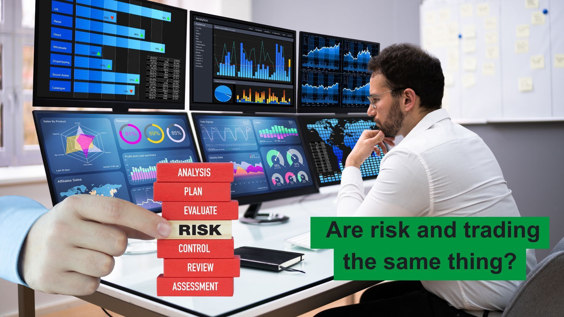 trader sitting at desk with bank of screens on it