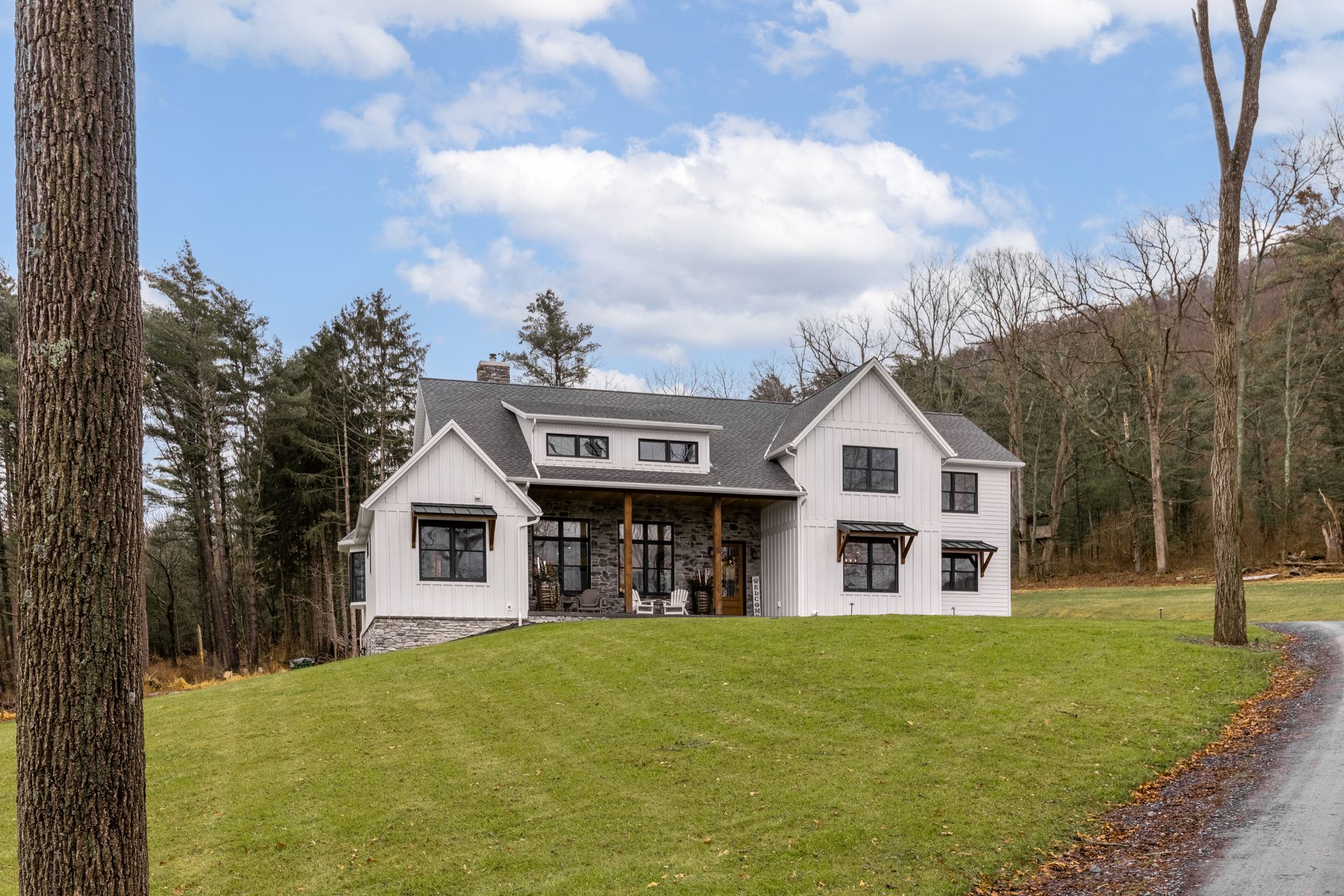 Custom farm house style home, white siding and black windows, trim in
State College, PA