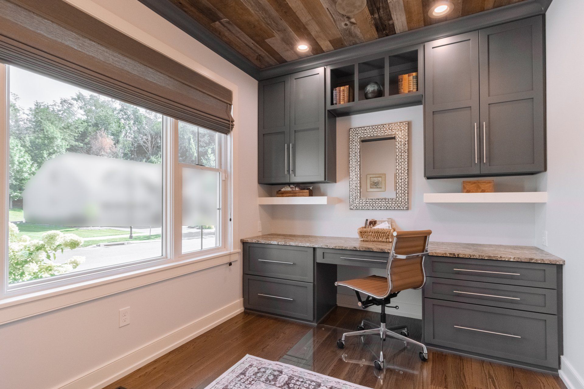 Home office with large window and custom built in shelving, custom State College, PA home