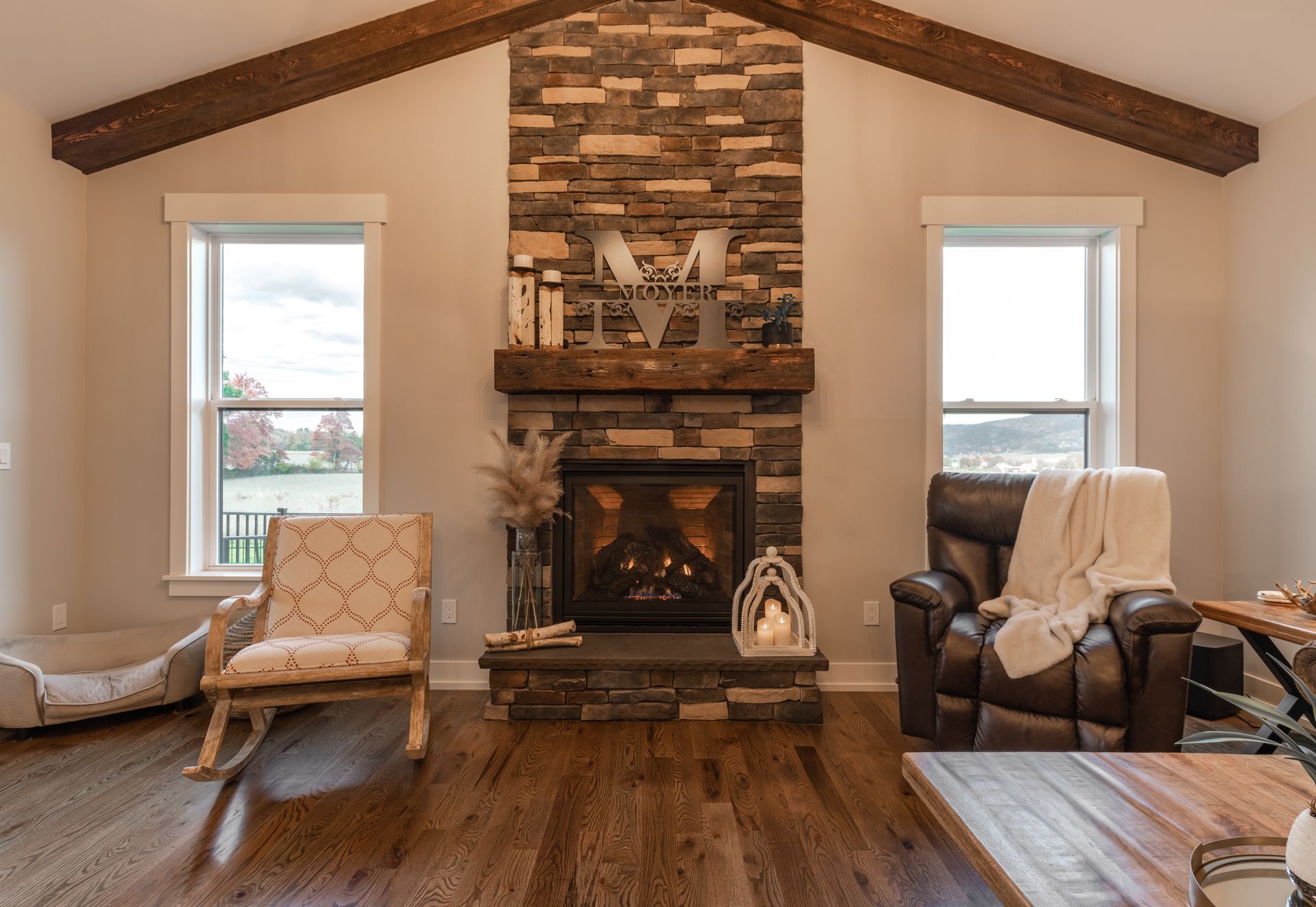 Custom home living room with fireplace, beams State College, PA