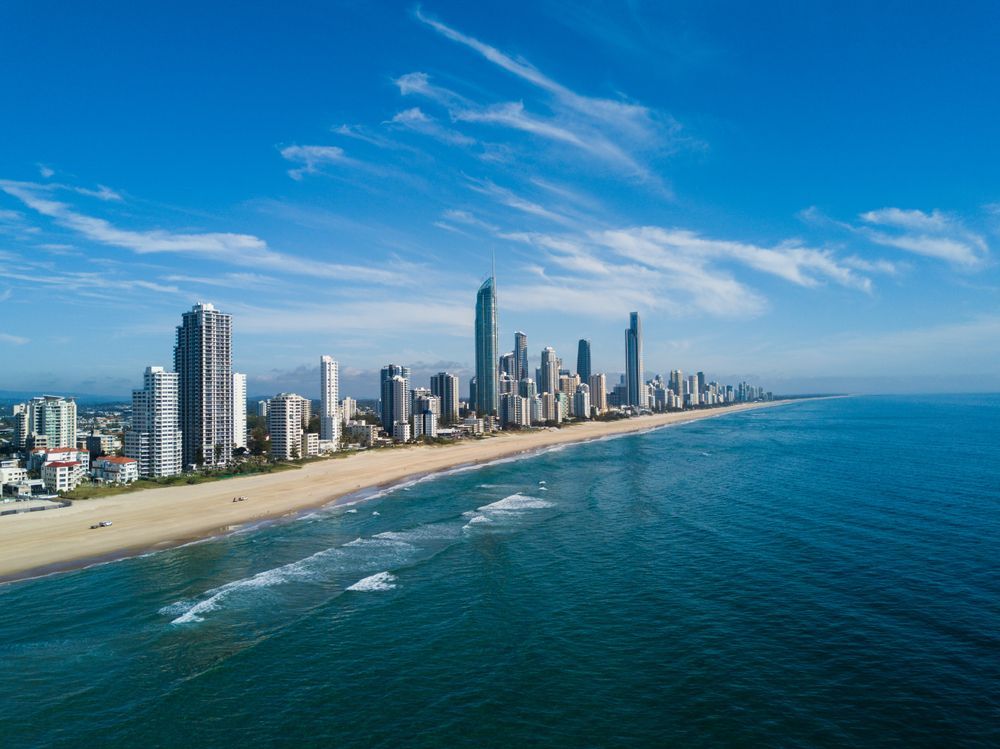 An Aerial View of A City Skyline Overlooking the Ocean — PEPS Machinery Services In Bethania, QLD