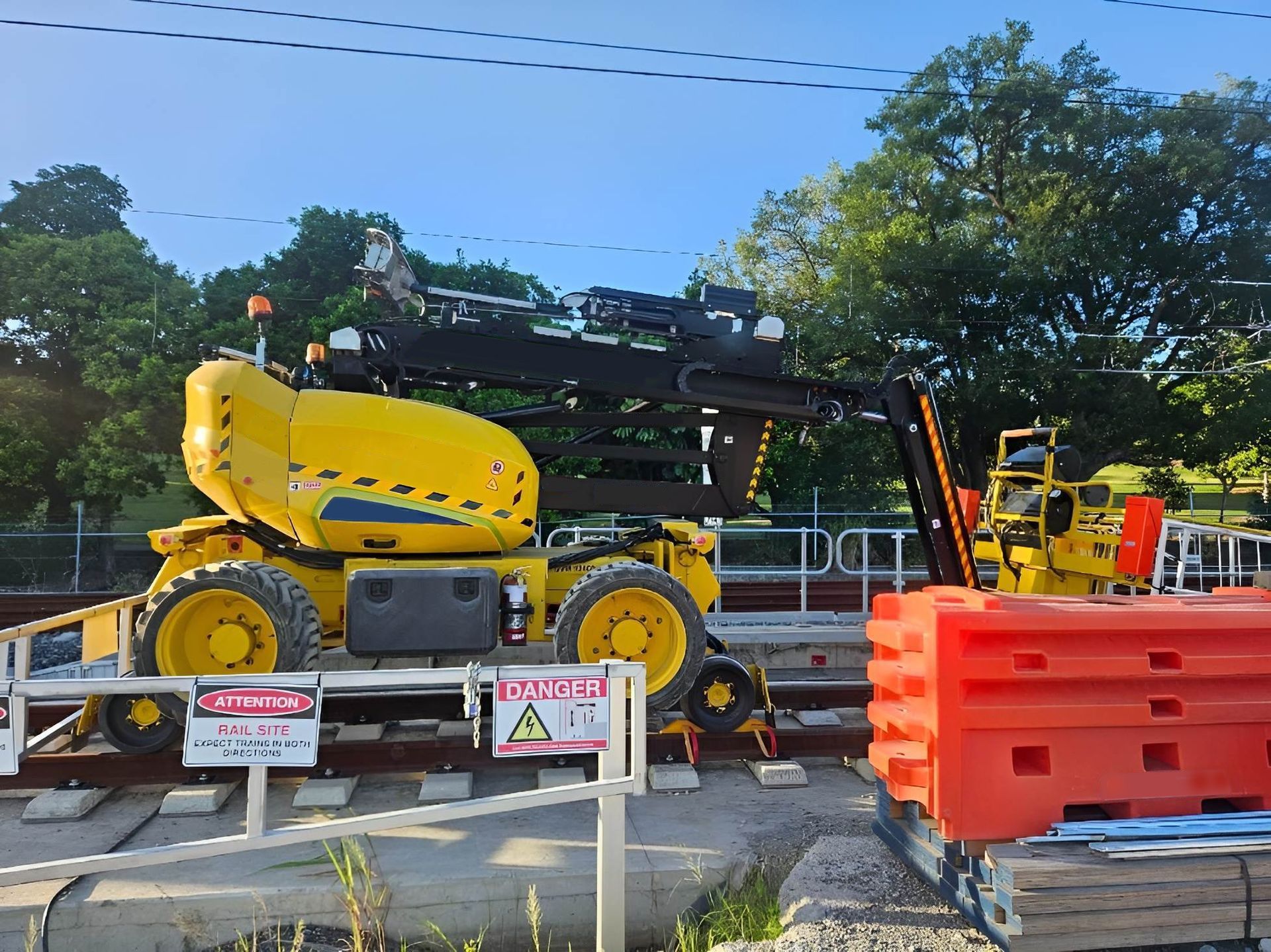 A Yellow Crane Is Parked at A Railroad Crossing — PEPS Machinery Services In Bethania, QLD