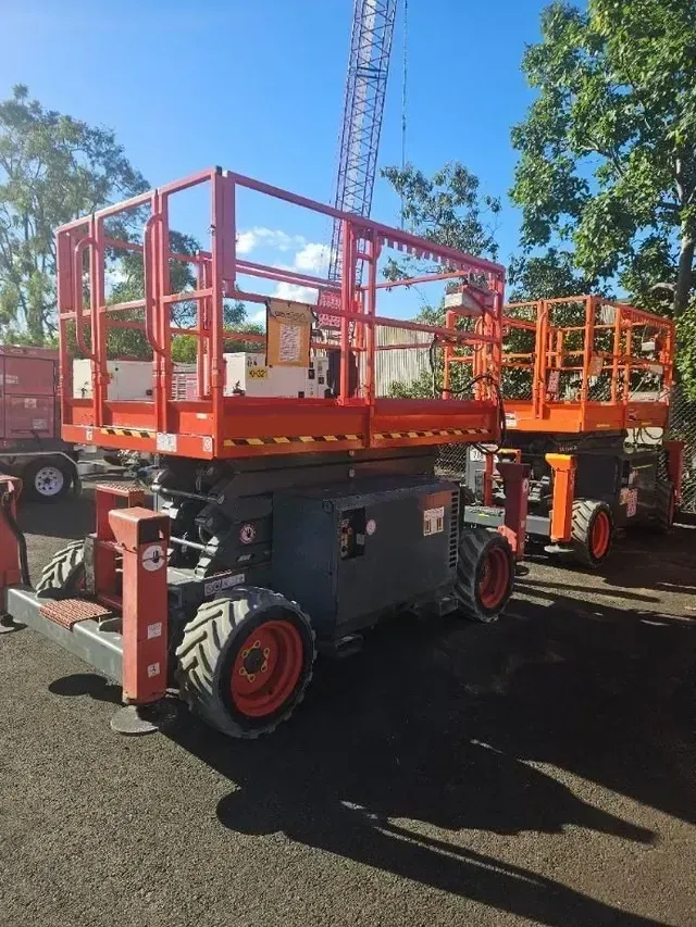 A Row of Scissor Lifts Are Parked in A Parking Lot — PEPS Machinery Services In Bethania, QLD