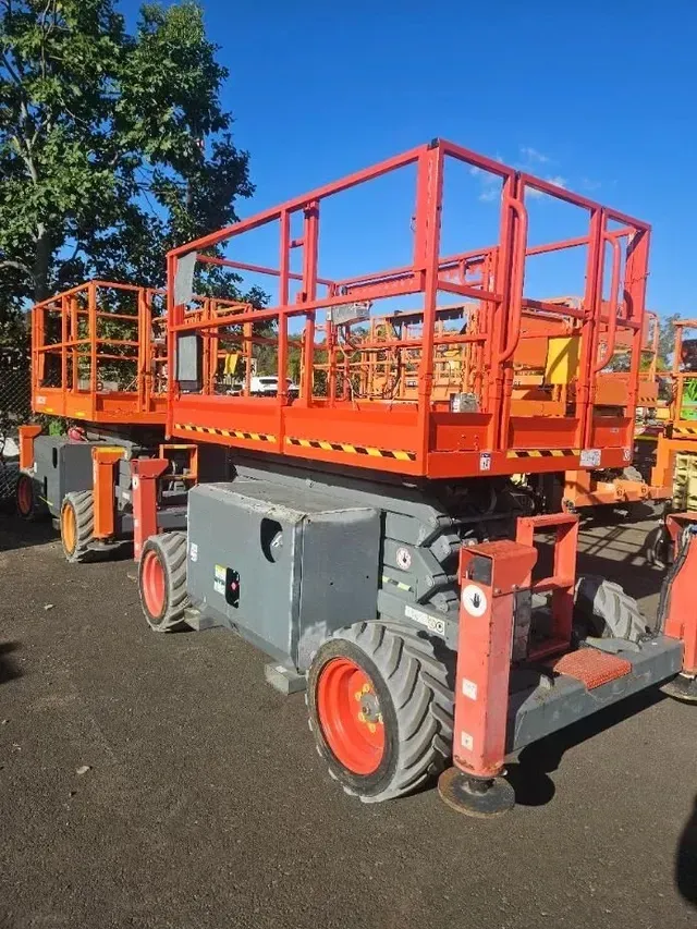 A Row of Aerial Lifts Are Parked in A Parking Lot — PEPS Machinery Services In Bethania, QLD