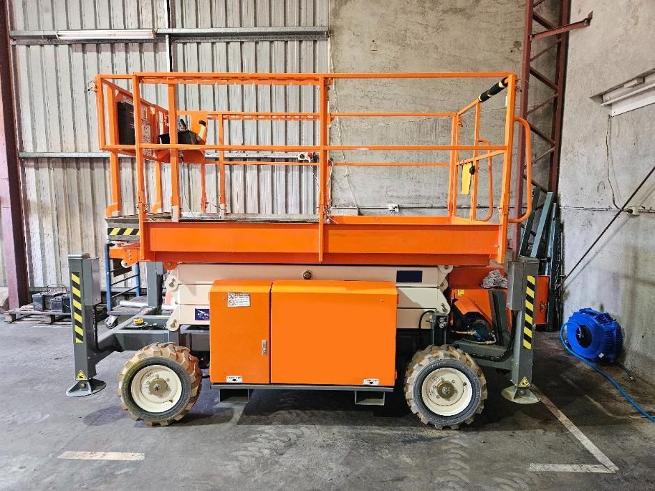 An Orange Snorkel Lift Is Parked in A Warehouse — PEPS Machinery Services In Bethania, QLD